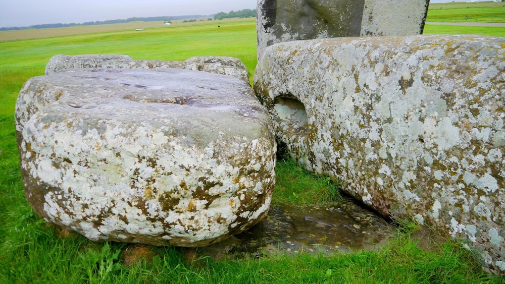 The Altar Stone lying recumbent beneath the fallen trilithon at Stonehenge